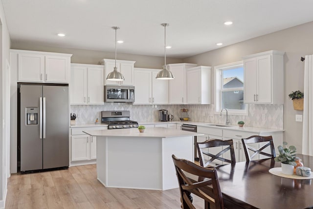 2141 Johanna Cir, Lino Lakes, MN 55038 - kitchen featuring light countertops, a sink, white cabinetry, and stainless steel appliances