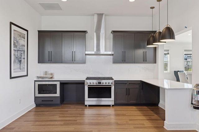 2141 Johanna Cir, Lino Lakes, MN 55038 - kitchen with a peninsula, wall chimney range hood, light countertops, built in microwave, and high end range