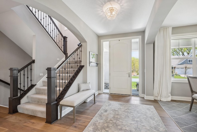 4233 Halstead Bay Alcove, Minnetrista, MN 55331 - entrance foyer with baseboards, stairs, wood finished floors, and a chandelier