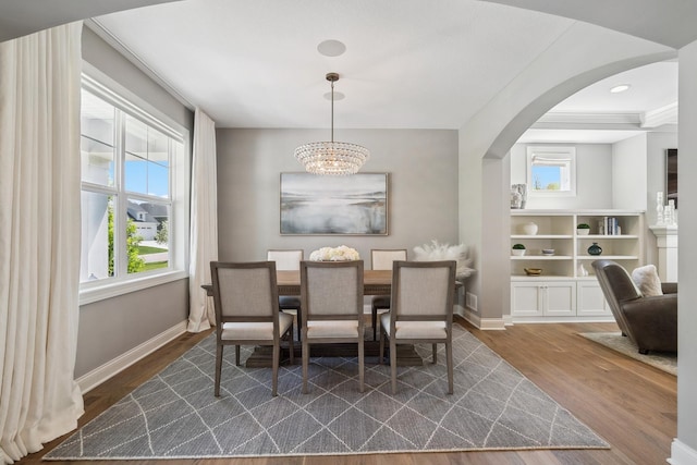 4233 Halstead Bay Alcove, Minnetrista, MN 55331 - dining area with arched walkways, dark wood-style flooring, a chandelier, and baseboards