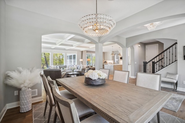 4233 Halstead Bay Alcove, Minnetrista, MN 55331 - dining area featuring a chandelier, arched walkways, baseboards, coffered ceiling, and dark wood finished floors