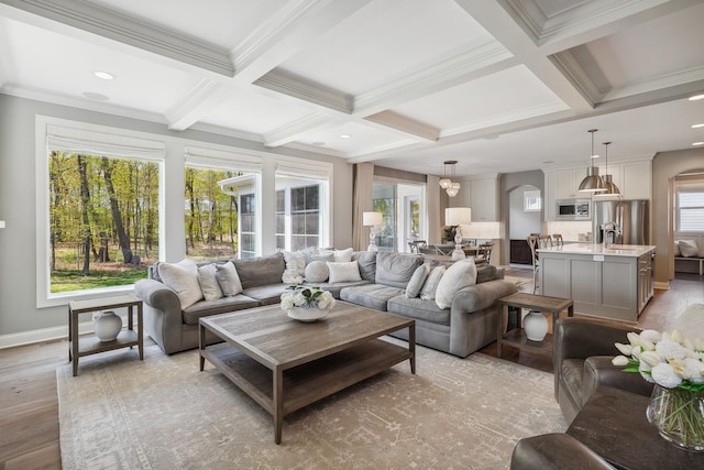 4233 Halstead Bay Alcove, Minnetrista, MN 55331 - living area featuring arched walkways, coffered ceiling, light wood-style flooring, beam ceiling, and baseboards