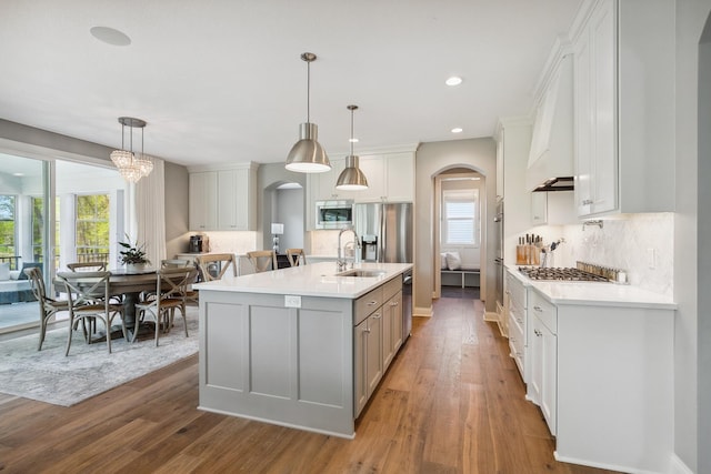 4233 Halstead Bay Alcove, Minnetrista, MN 55331 - kitchen featuring arched walkways, a sink, stainless steel appliances, light countertops, and recessed lighting