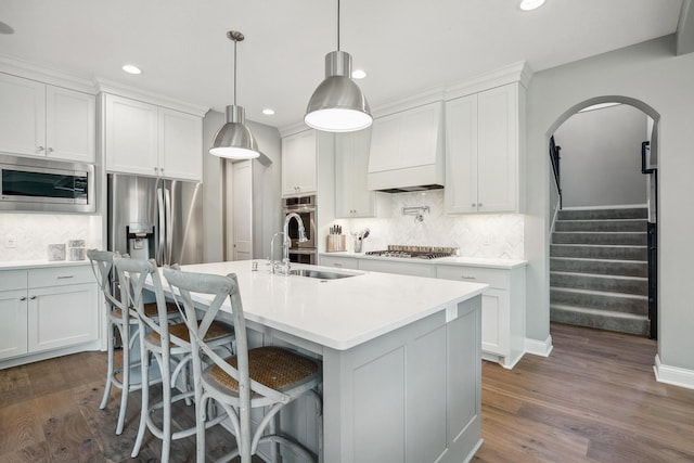 4233 Halstead Bay Alcove, Minnetrista, MN 55331 - kitchen with stainless steel appliances, a sink, dark wood-style flooring, recessed lighting, and decorative backsplash