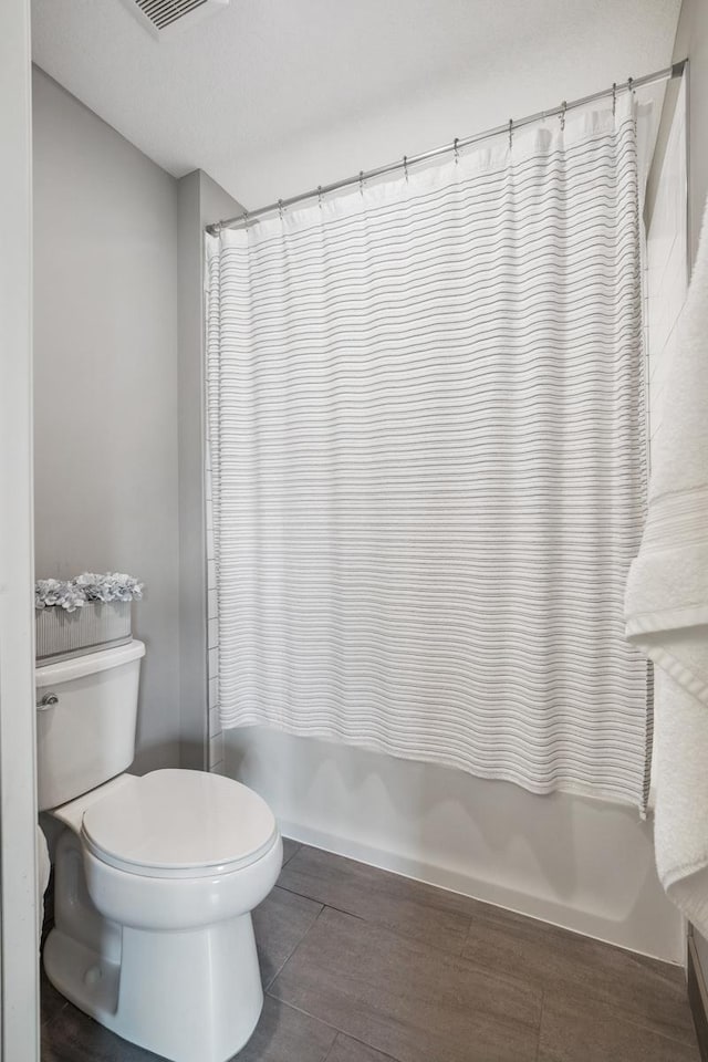 4233 Halstead Bay Alcove, Minnetrista, MN 55331 - bathroom with toilet, shower / tub combo with curtain, and wood finished floors