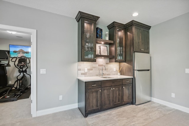4233 Halstead Bay Alcove, Minnetrista, MN 55331 - kitchen with freestanding refrigerator, a sink, dark brown cabinets, tasteful backsplash, and light countertops