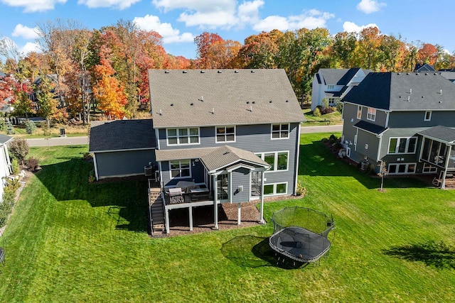 4233 Halstead Bay Alcove, Minnetrista, MN 55331 - rear view of house with a wooden deck, a yard, stairs, a shingled roof, and a trampoline