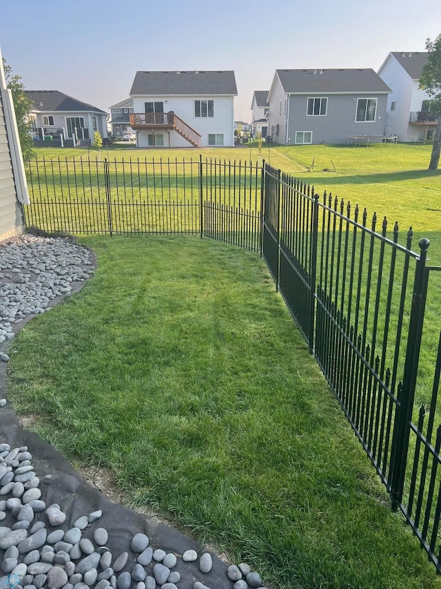 view of yard featuring a fenced backyard and a residential view
