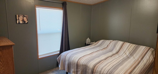 306 4th St S, Hoffman, MN 56339 - carpeted bedroom featuring a textured ceiling and a decorative wall