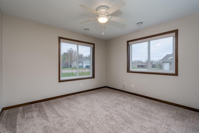 209 Plum Run, Le Sueur, MN 56058 - carpeted spare room featuring baseboards and a ceiling fan