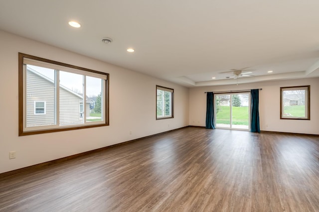 209 Plum Run, Le Sueur, MN 56058 - spare room featuring a raised ceiling, recessed lighting, wood finished floors, baseboards, and a ceiling fan