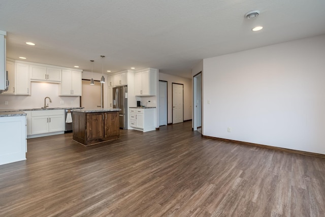 209 Plum Run, Le Sueur, MN 56058 - kitchen with stainless steel appliances, dark wood-style flooring, white cabinets, a center island, and recessed lighting