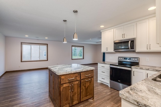 209 Plum Run, Le Sueur, MN 56058 - kitchen with appliances with stainless steel finishes, dark wood-style flooring, a center island, recessed lighting, and white cabinets