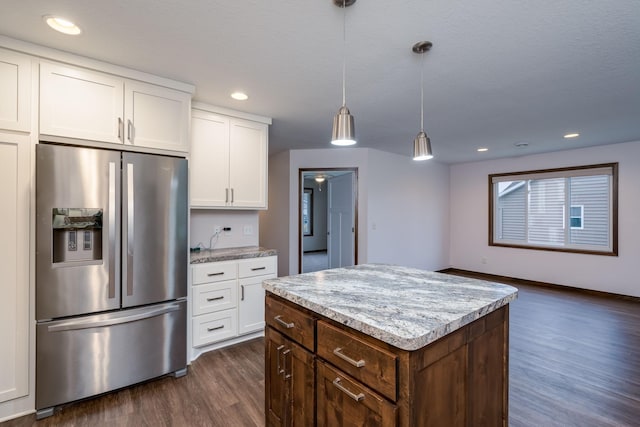 209 Plum Run, Le Sueur, MN 56058 - kitchen featuring stainless steel refrigerator with ice dispenser, dark wood finished floors, white cabinetry, pendant lighting, and a kitchen island