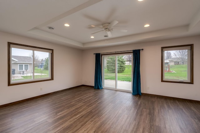 209 Plum Run, Le Sueur, MN 56058 - spare room with a raised ceiling, dark wood-style floors, baseboards, and recessed lighting