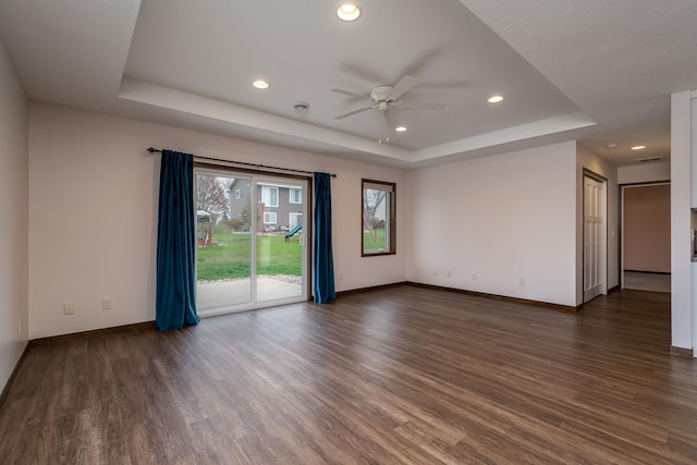 209 Plum Run, Le Sueur, MN 56058 - spare room featuring a raised ceiling, a ceiling fan, dark wood-style floors, baseboards, and recessed lighting