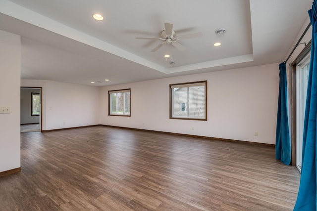 209 Plum Run, Le Sueur, MN 56058 - spare room with a ceiling fan, baseboards, wood finished floors, a tray ceiling, and recessed lighting