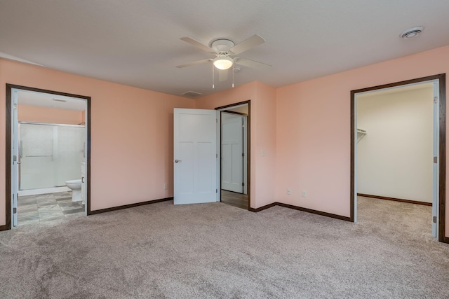 209 Plum Run, Le Sueur, MN 56058 - unfurnished bedroom featuring carpet, baseboards, a spacious closet, ensuite bath, and ceiling fan