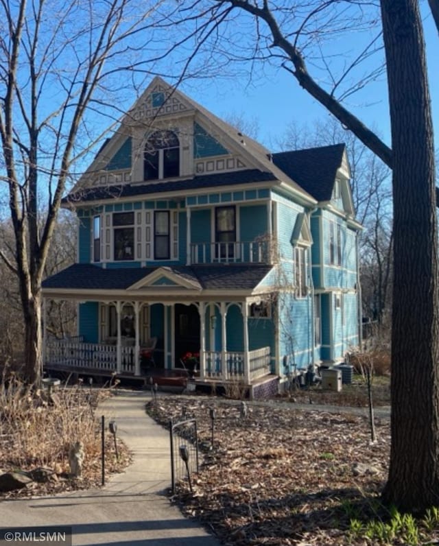 victorian home with a balcony and covered porch