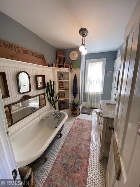 bathroom with vanity, a soaking tub, and a stall shower