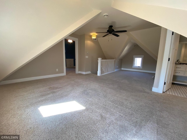 bonus room featuring carpet floors, a ceiling fan, vaulted ceiling, and baseboards