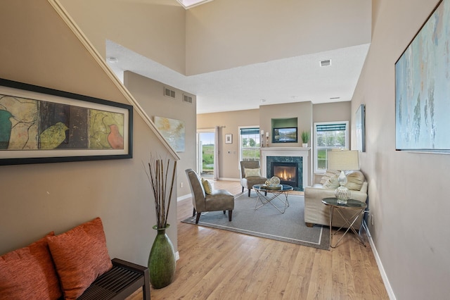 7619 Derby Ln, Shakopee, MN 55379 - living area featuring wood finished floors, baseboards, a high end fireplace, and plenty of natural light