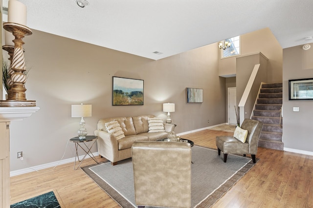 7619 Derby Ln, Shakopee, MN 55379 - living room with wood finished floors, stairs, baseboards, and a chandelier