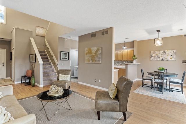 7619 Derby Ln, Shakopee, MN 55379 - living area featuring light wood finished floors, stairs, and baseboards