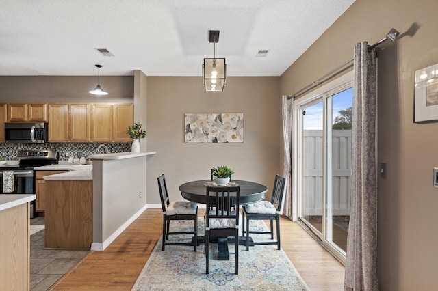 7619 Derby Ln, Shakopee, MN 55379 - dining space featuring light wood-type flooring and a textured ceiling