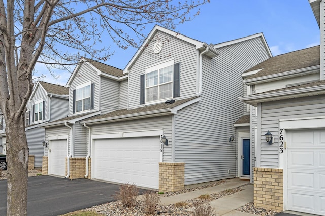 7619 Derby Ln, Shakopee, MN 55379 - view of front of house featuring a garage, driveway, and brick siding