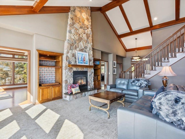 living area featuring high vaulted ceiling, healthy amount of natural light, stairway, beam ceiling, and a stone fireplace