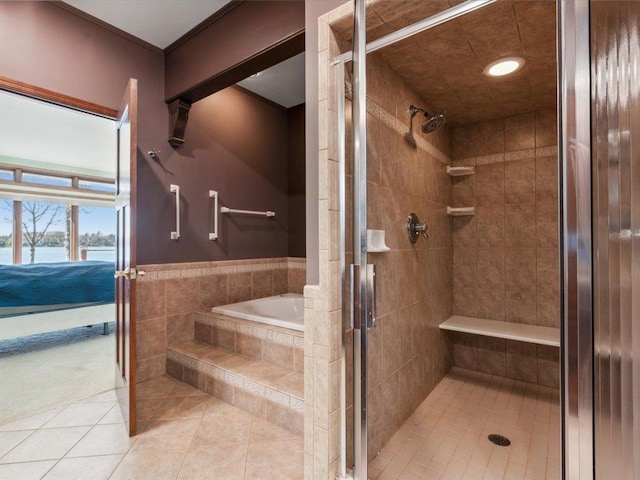 full bathroom featuring tile patterned flooring, a shower stall, a water view, and recessed lighting