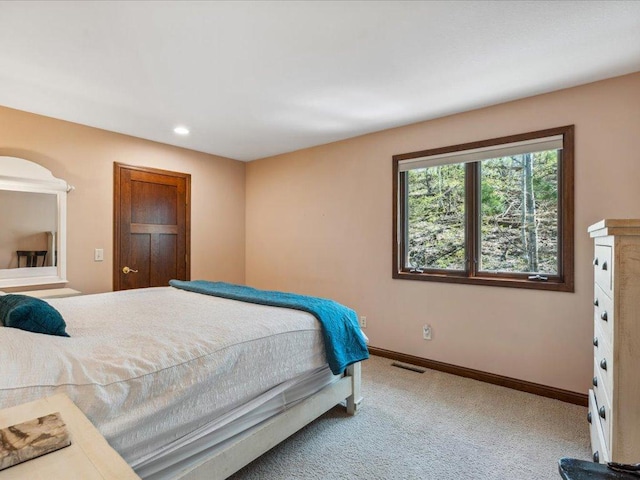 carpeted bedroom featuring baseboards and recessed lighting