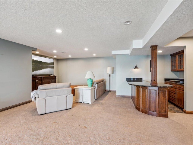 living area featuring light carpet, a textured ceiling, recessed lighting, bar, and baseboards