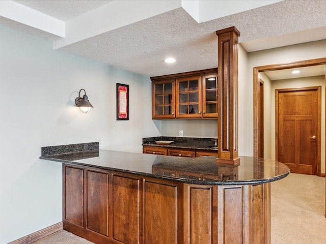 bar area featuring light carpet, recessed lighting, decorative columns, a textured ceiling, and baseboards