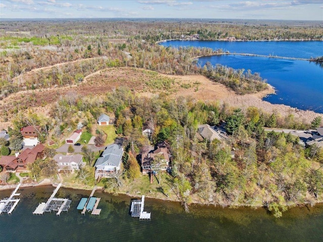 aerial overview of property's location featuring a nearby body of water and a heavily wooded area