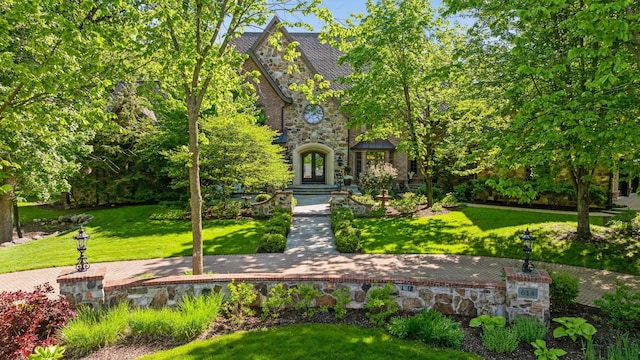 614 Hidden Creek Trl, Mendota Heights, MN 55118 - view of front of property with stone siding, a front lawn, and a high end roof