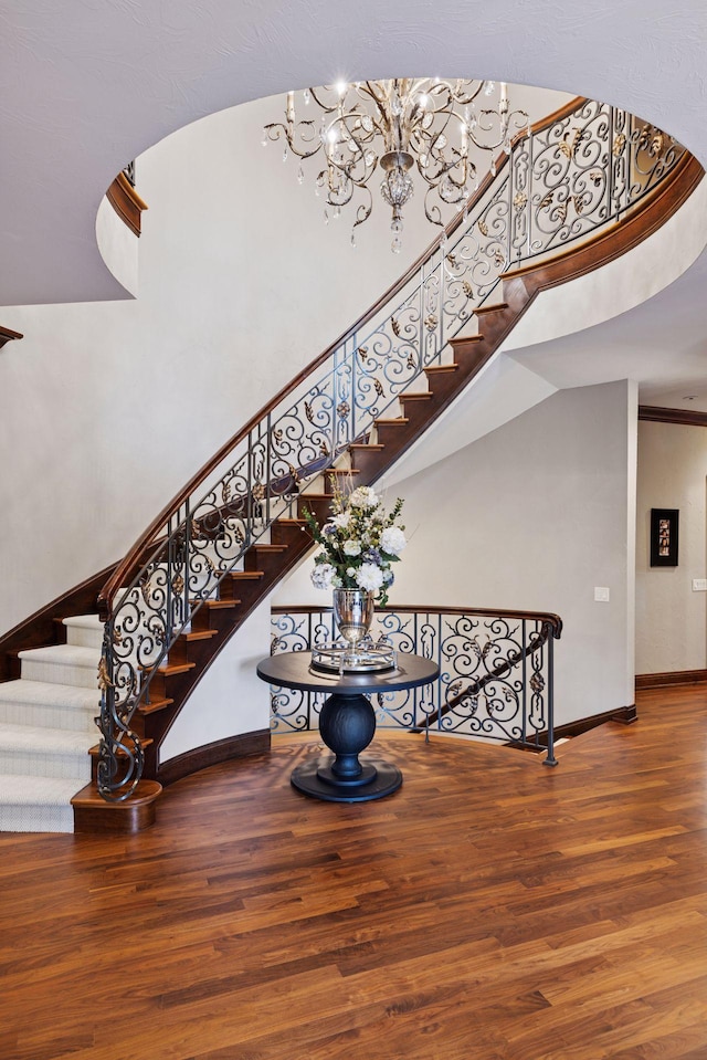 614 Hidden Creek Trl, Mendota Heights, MN 55118 - staircase with wood finished floors, a high ceiling, a chandelier, and baseboards