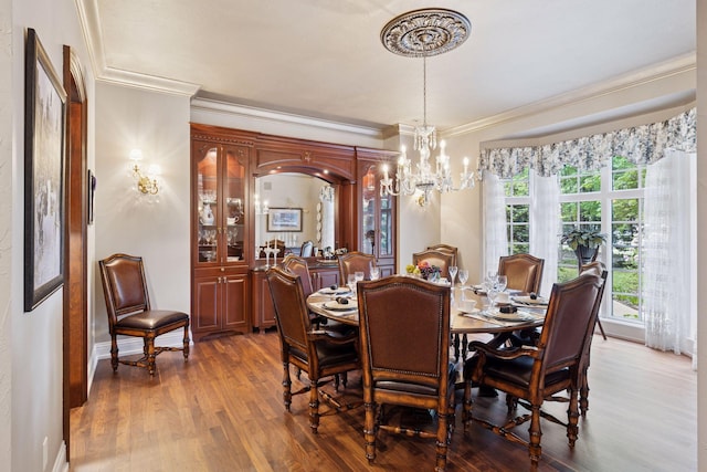 614 Hidden Creek Trl, Mendota Heights, MN 55118 - dining space with crown molding, wood finished floors, a chandelier, and baseboards