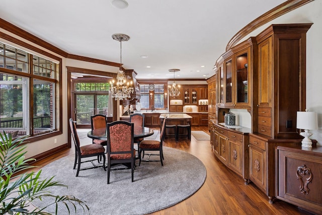614 Hidden Creek Trl, Mendota Heights, MN 55118 - dining area with a chandelier, wood finished floors, and crown molding