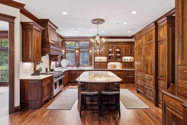 614 Hidden Creek Trl, Mendota Heights, MN 55118 - kitchen featuring range with two ovens, a kitchen island, a chandelier, dark wood-type flooring, and recessed lighting