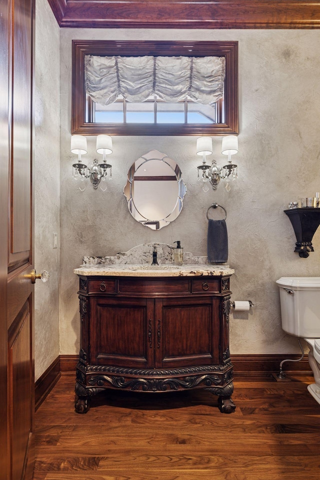 614 Hidden Creek Trl, Mendota Heights, MN 55118 - half bathroom featuring wood finished floors, vanity, toilet, and baseboards