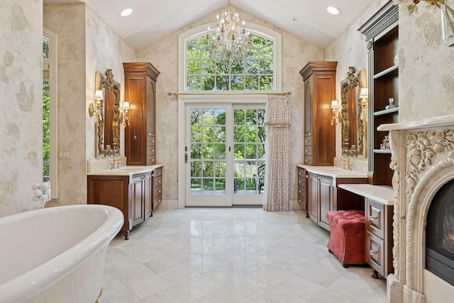 614 Hidden Creek Trl, Mendota Heights, MN 55118 - bathroom featuring lofted ceiling, a freestanding bath, two vanities, a chandelier, and a fireplace