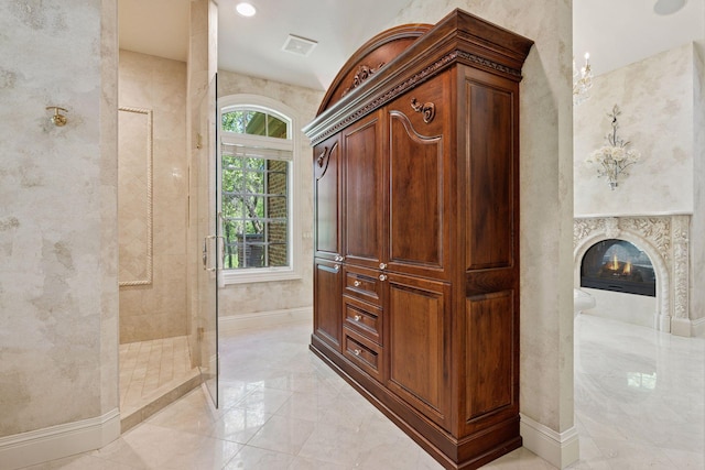 614 Hidden Creek Trl, Mendota Heights, MN 55118 - full bathroom with walk in shower, marble tiled flooring, baseboards, and a fireplace