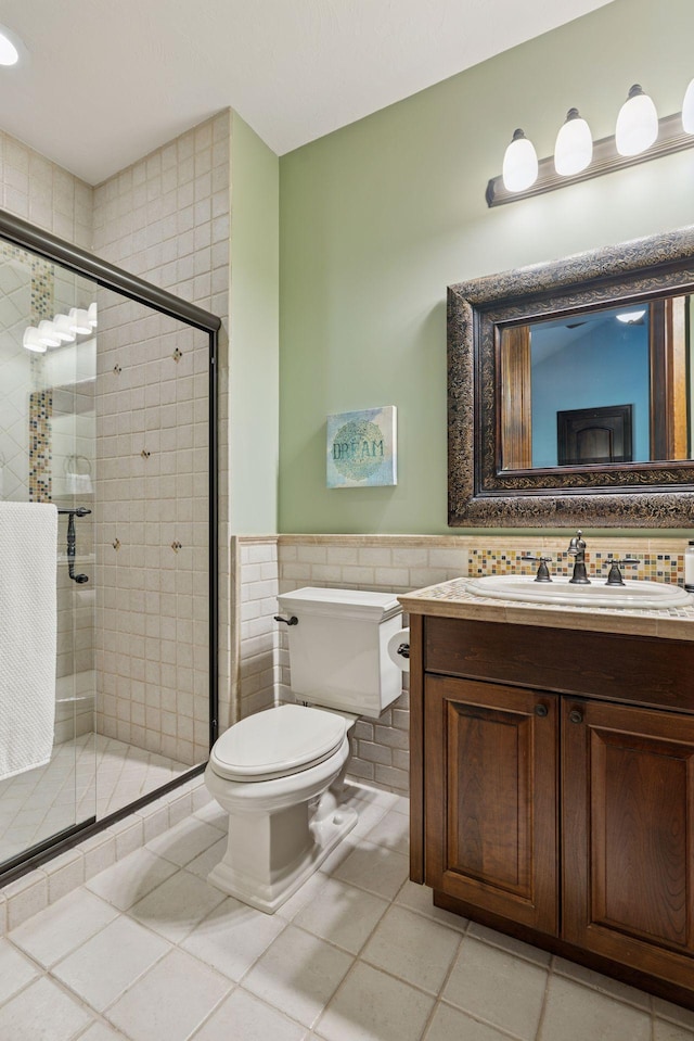 614 Hidden Creek Trl, Mendota Heights, MN 55118 - bathroom featuring tile walls, toilet, vanity, a wainscoted wall, and tile patterned flooring