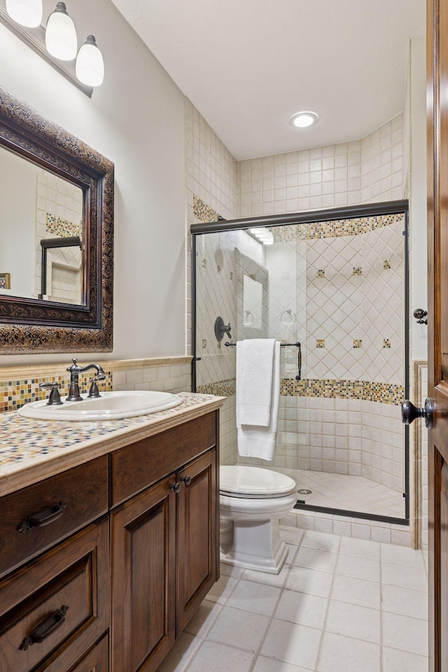614 Hidden Creek Trl, Mendota Heights, MN 55118 - bathroom featuring tile walls, toilet, vanity, a shower stall, and tile patterned floors