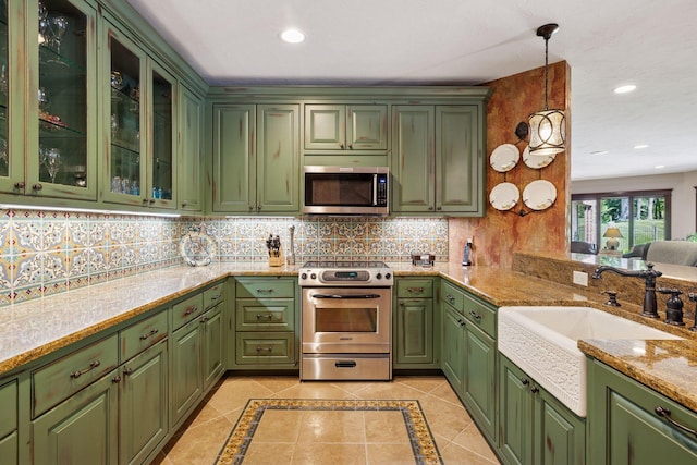 614 Hidden Creek Trl, Mendota Heights, MN 55118 - kitchen featuring stainless steel appliances, green cabinets, a sink, decorative backsplash, and recessed lighting