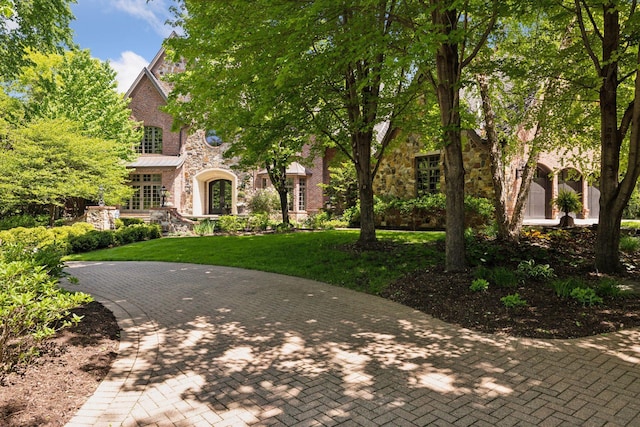 614 Hidden Creek Trl, Mendota Heights, MN 55118 - view of front facade with stone siding and a front lawn
