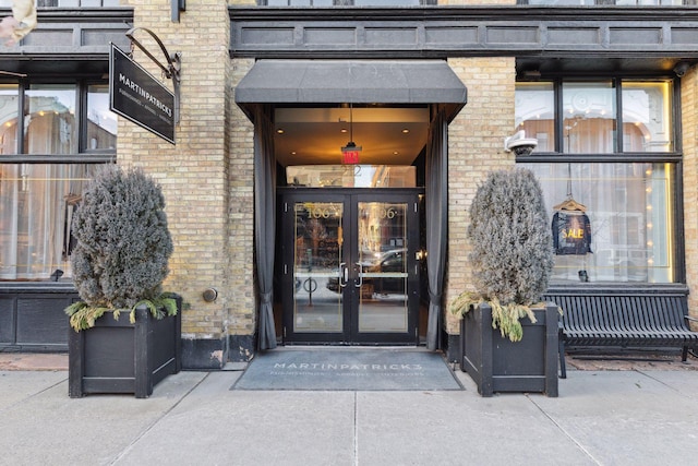 entrance to property with french doors and brick siding