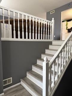 1415 Trailwood Ln SW, Faribault, MN 55021 - stairway featuring wood finished floors and baseboards